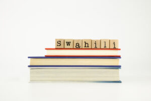 Swahili word on wood stamps stack on books por Vinnstock